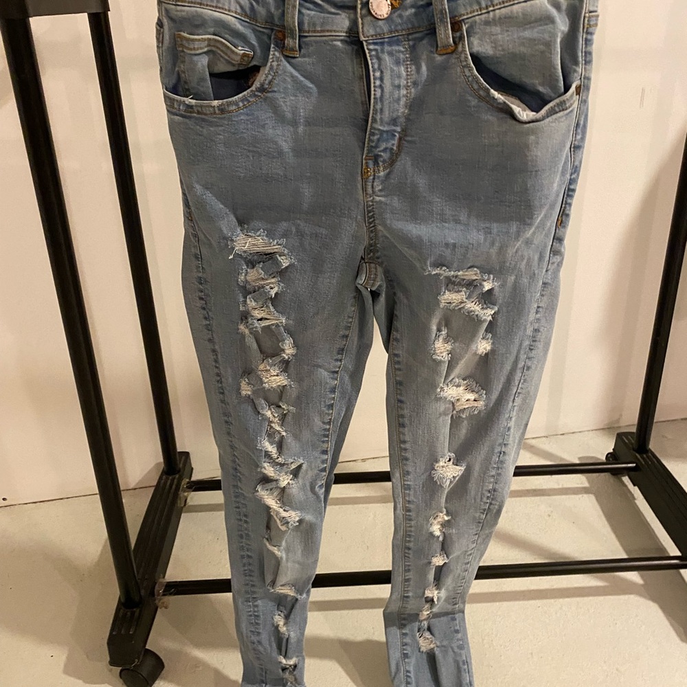 Medium blue jeans. Ripped on legs